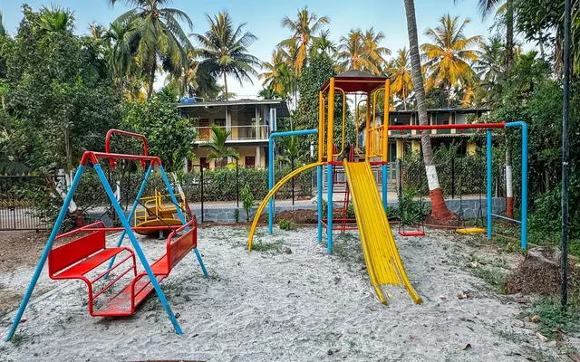 Swings and slides in the children's play area at Airawat