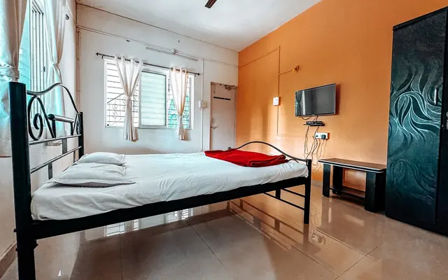 Executive room at Airawat with a double bed, TV and air conditioning