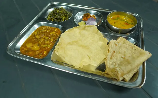 Vegetarian thali with papad, dal and vegetables at Airawat