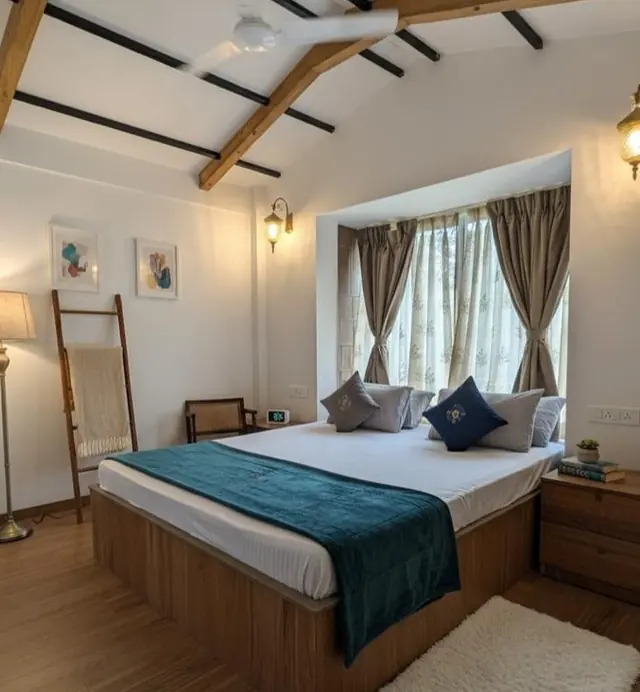 Upstairs bedroom at the Little Red Cottage under a wooden ceiling