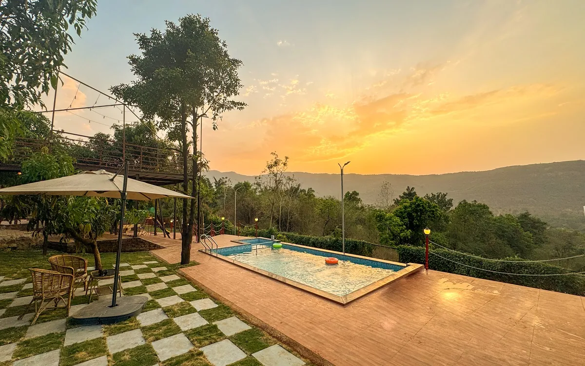 The pool at Redroof Farmhouse at sunset, with the valley beyond