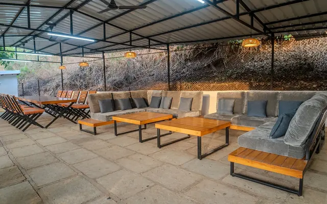 Covered lounge with sofas and low tables at Redroof